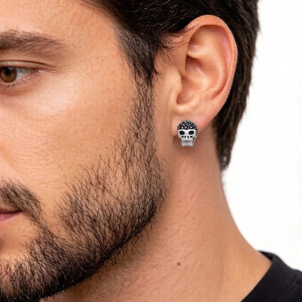Boucle d'oreille tête de mort à zircons noirs portée par un homme